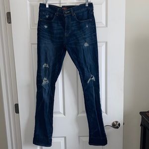 Distressed dark blue jeans